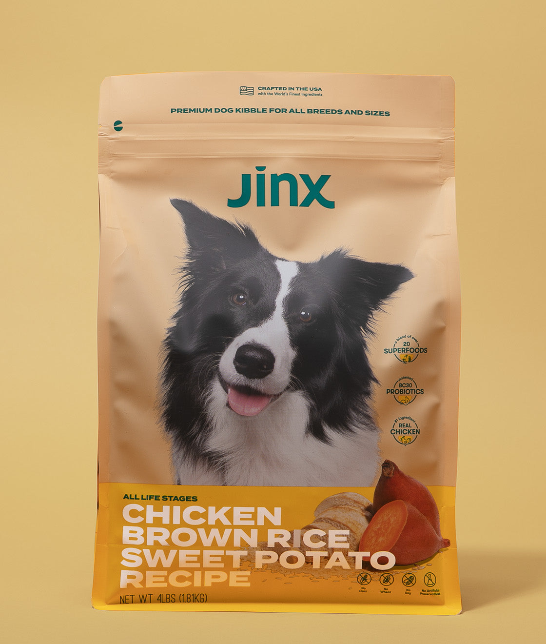 Chicken essentials Jinx bundle with chicken, brown rice & sweet potato Jinx dog kibble product packaging on yellow background.