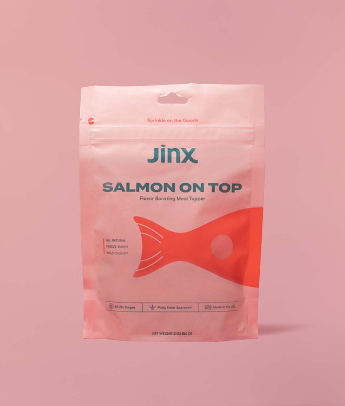 Salmon topper Jinx product packaging on a pink background