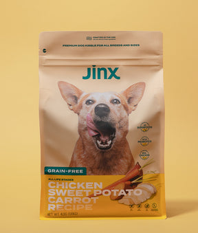 Grain-free chicken essentials Jinx bundle including chicken, sweet potato & carrot Jinx dog kibble product packaging on a yellow background.