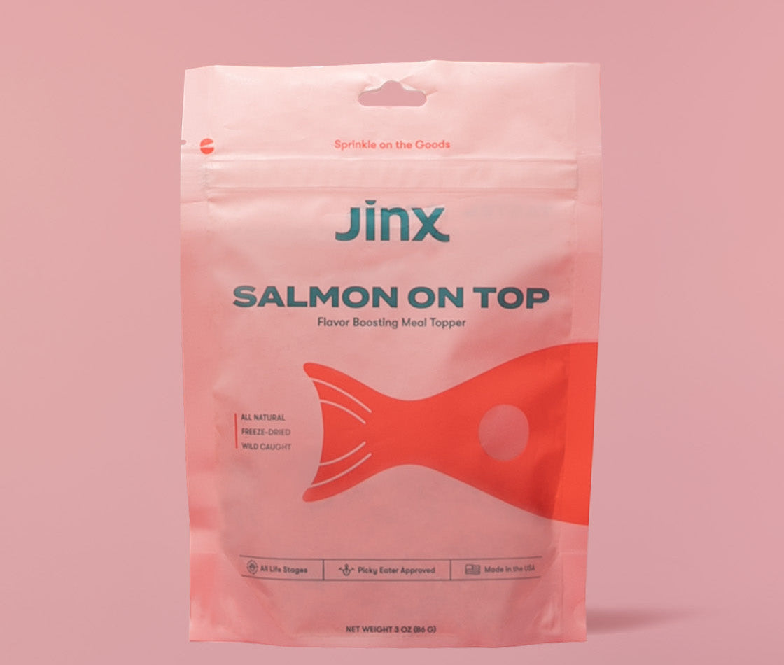Salmon topper Jinx product packaging on a pink background 